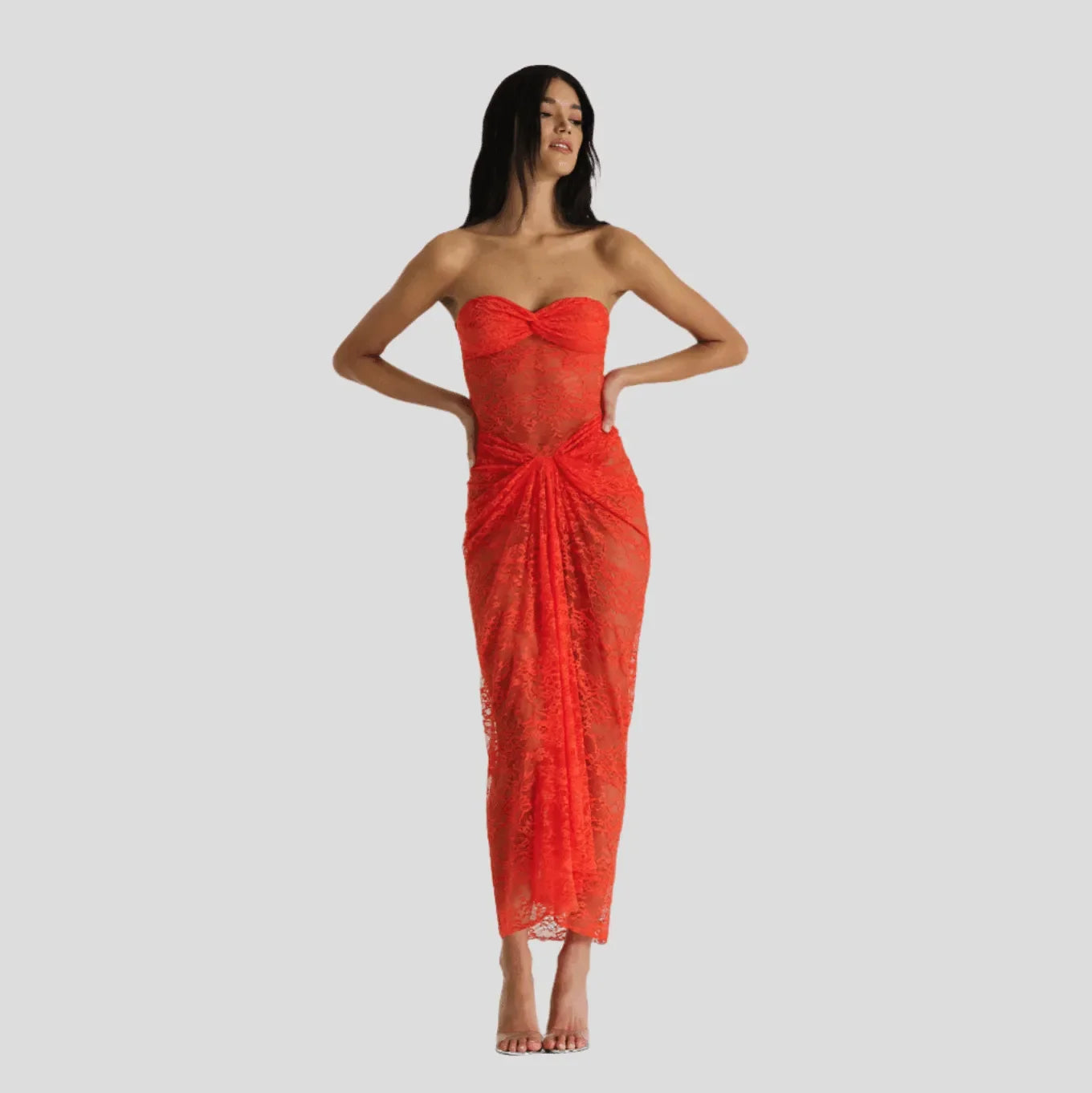 Off-shoulder orange lace maxi dress with a fitted bodice and draped detailing, elegantly styled for a special occasion.