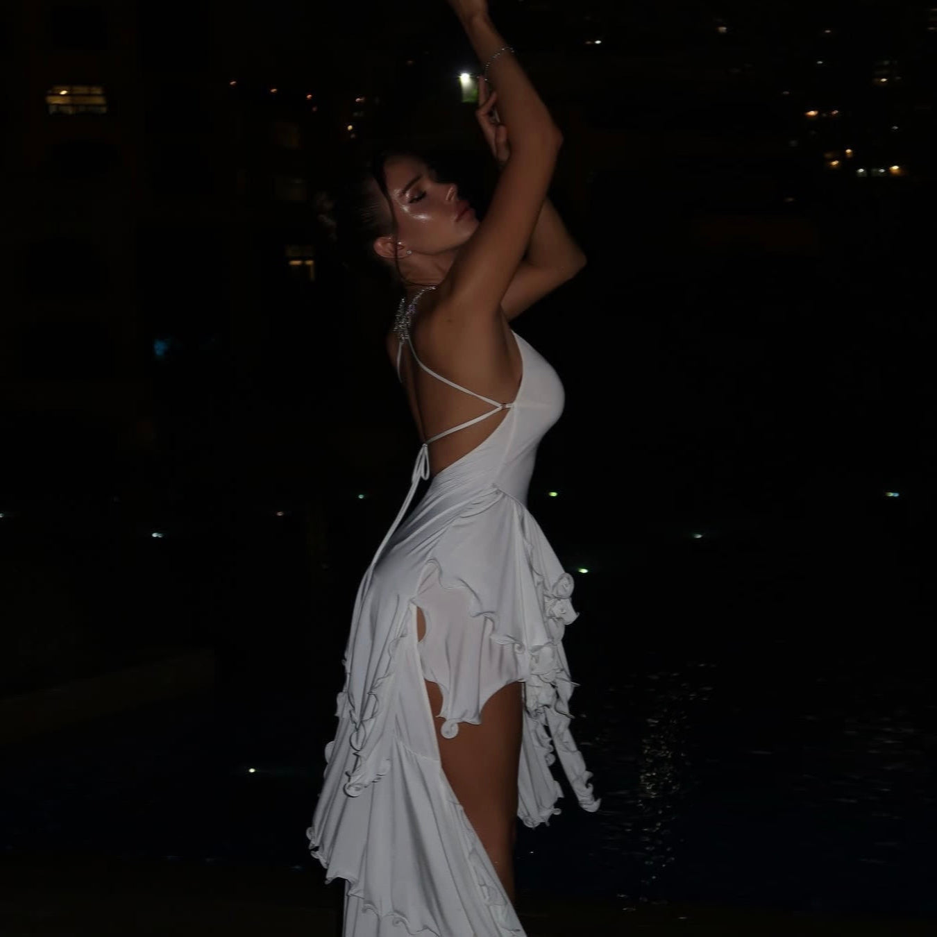 White ruffled midi dress with side slits, featuring a strappy back, perfect for evening events or summer parties.