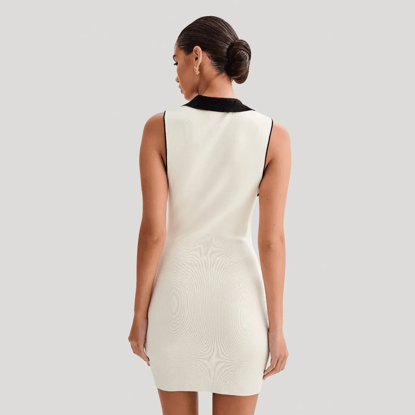 white sleeveless mini dress with black collar, classic style