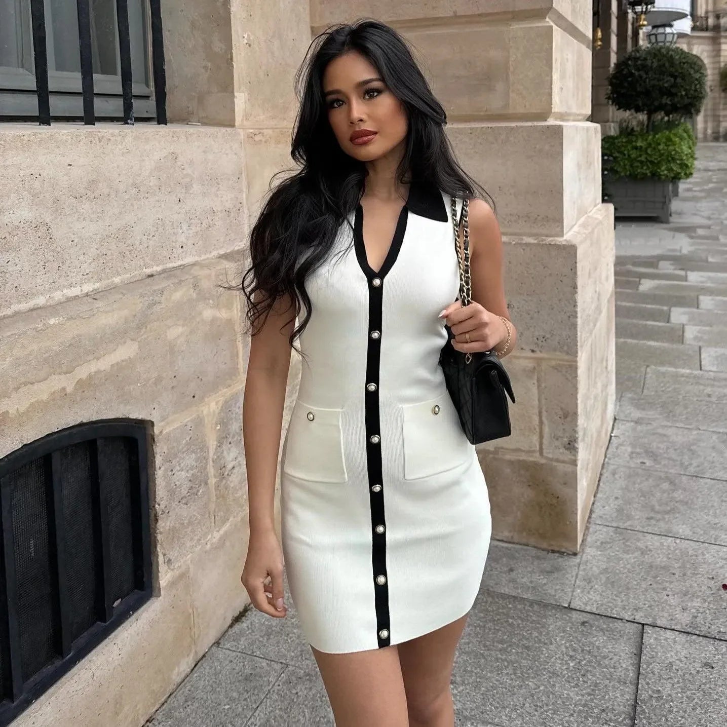 sleeveless button-up mini dress with black trim and pockets