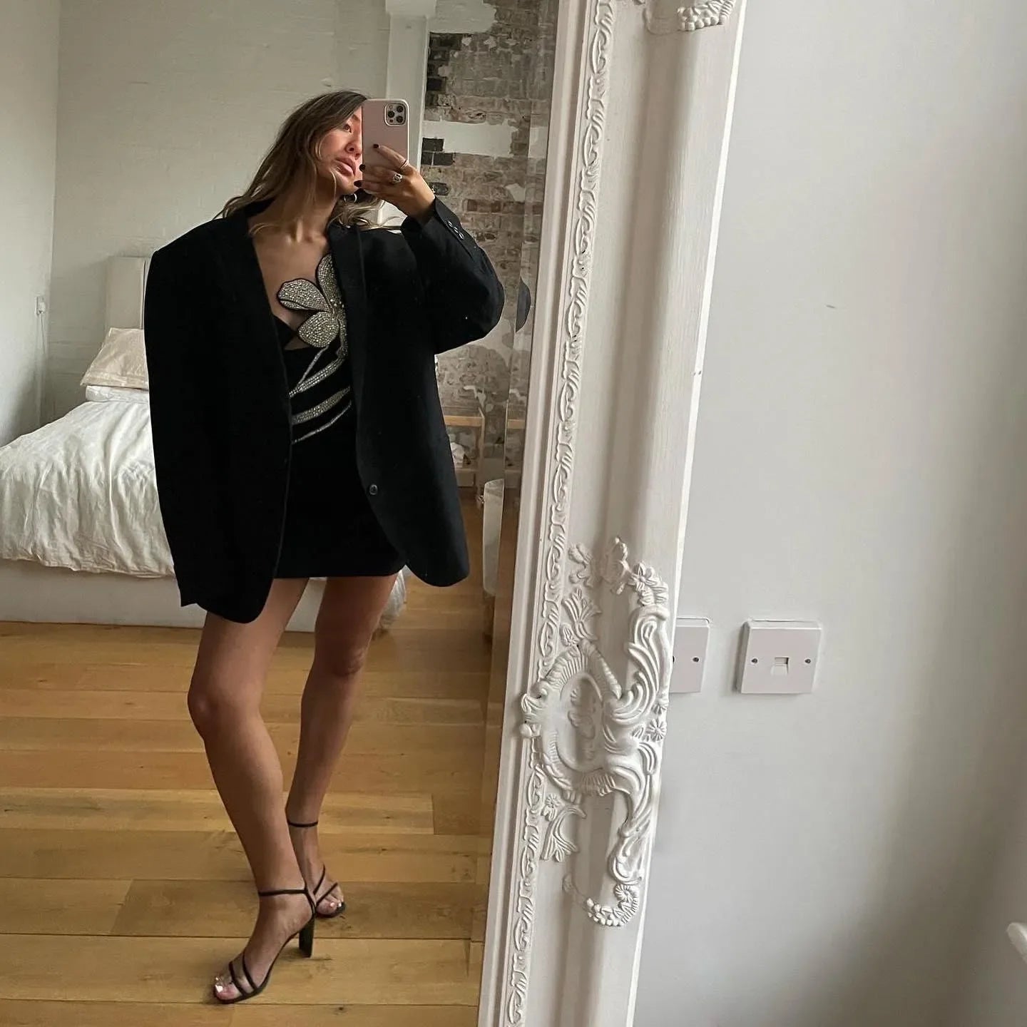 black mini dress with rhinestone floral design and oversized blazer, evening look