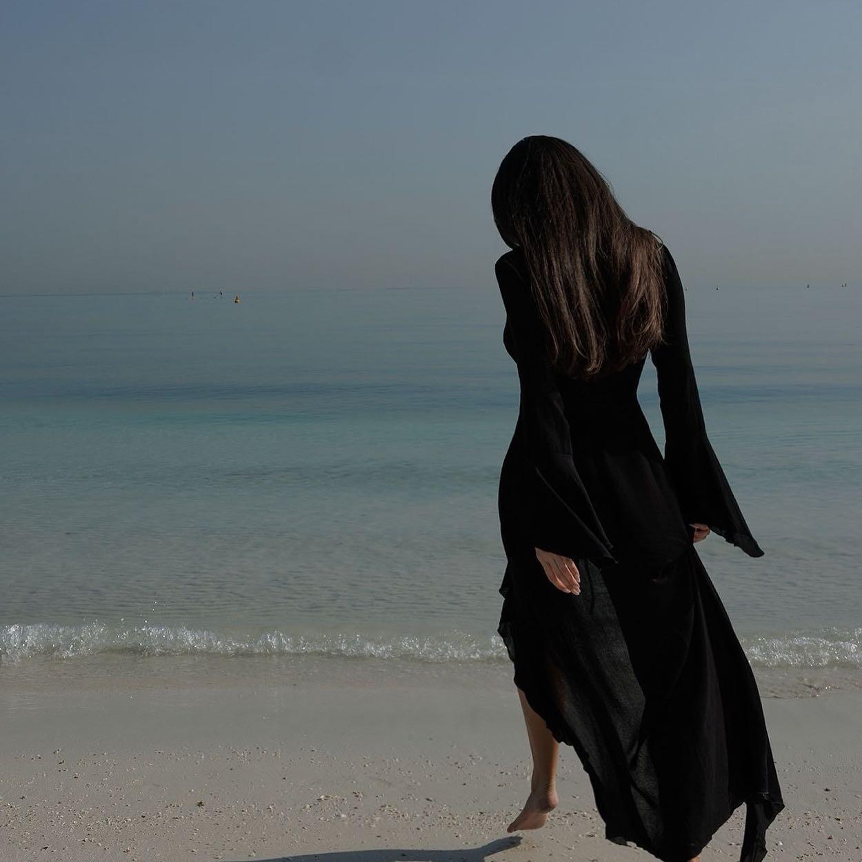 black flowy maxi dress with bell sleeves, beach style