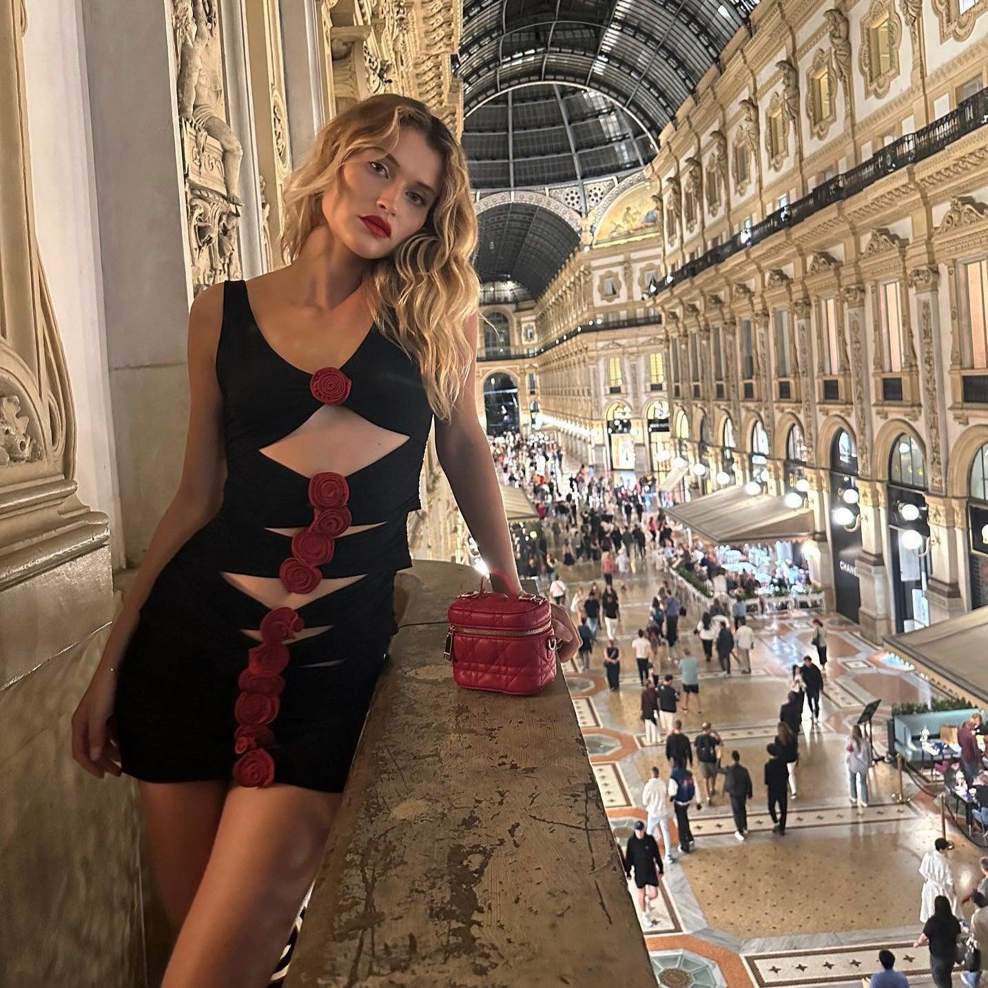 black cut-out mini dress with red floral accents, evening look