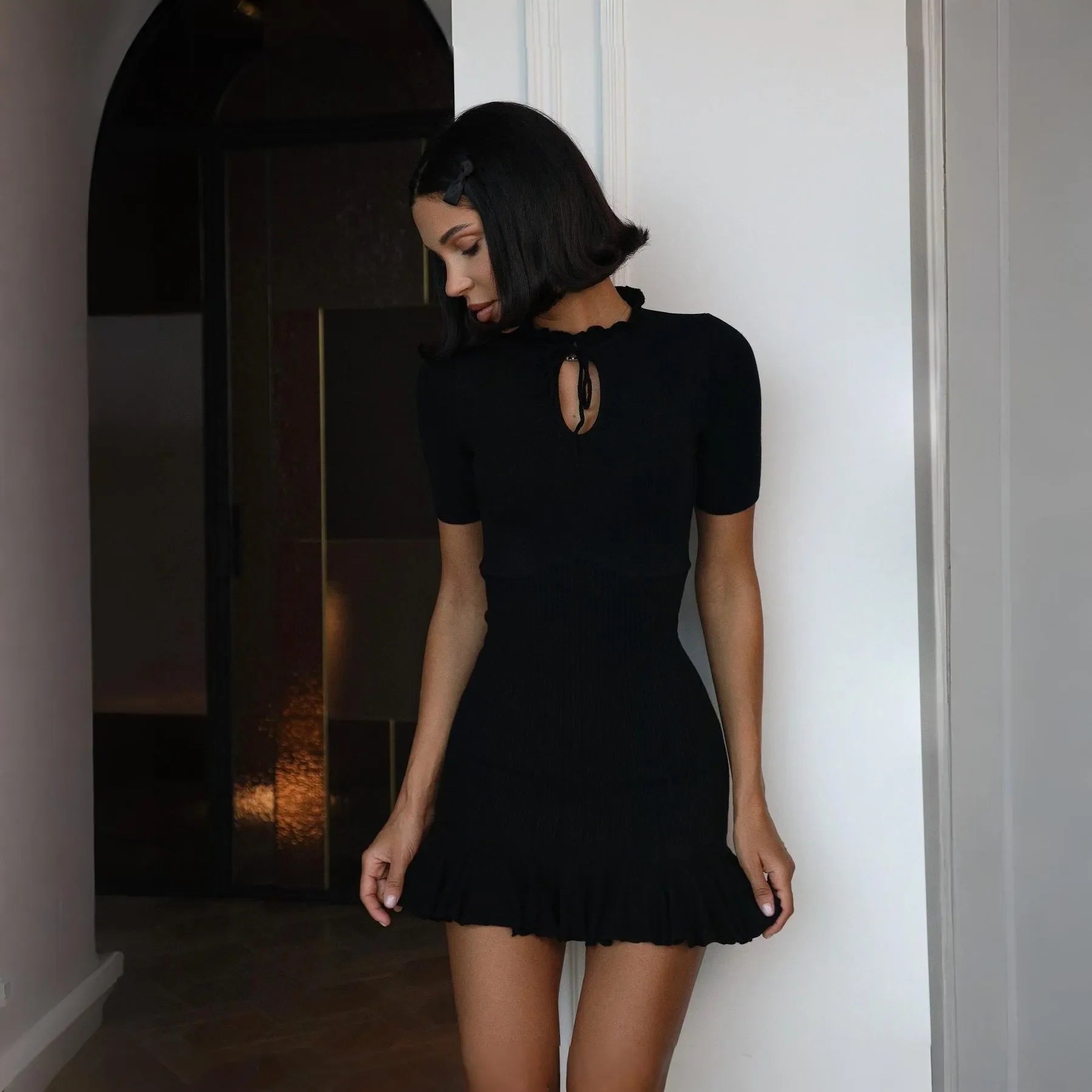 black mini dress with keyhole neckline and short sleeves