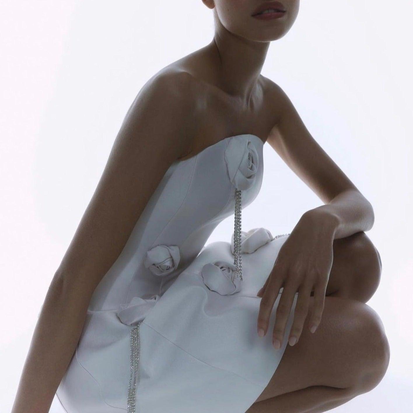 strapless white mini dress with floral embellishments and crystal fringe, evening look
