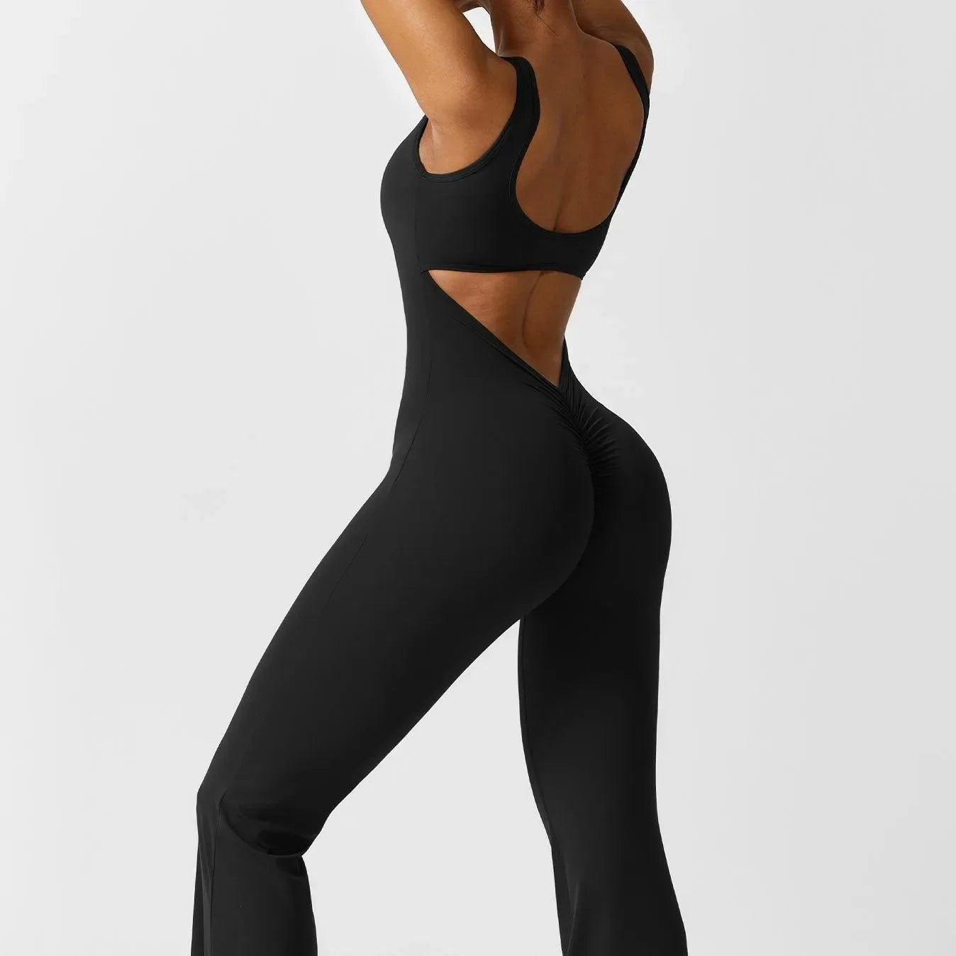 black backless jumpsuit with ruched detailing, evening look