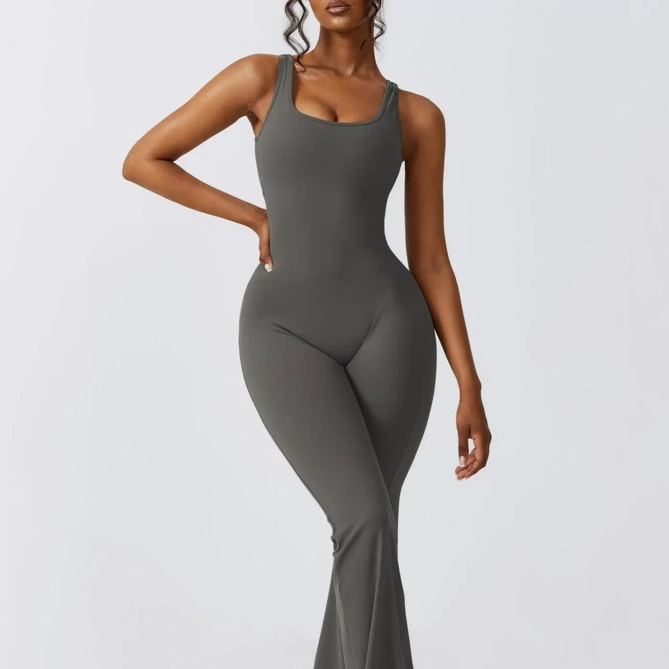 Gray push-up jumpsuit with scoop neckline and flared legs, styled for a form-fitting, chic look. Perfect for a night out.