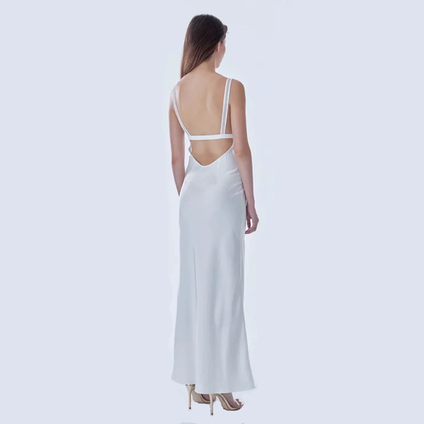 Backless white satin evening dress with thin straps.