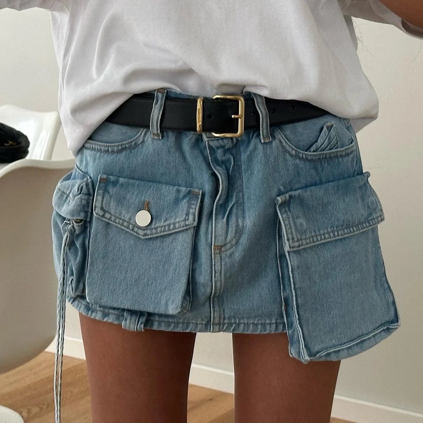 denim mini skirt with large cargo pockets and black belt