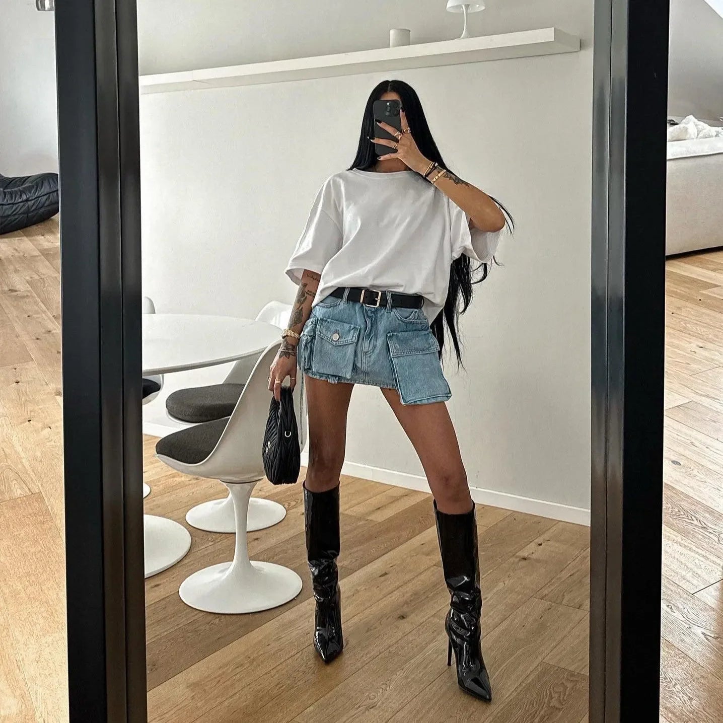 denim mini skirt with pockets, oversized white tee, black patent knee-high boots, casual stylish