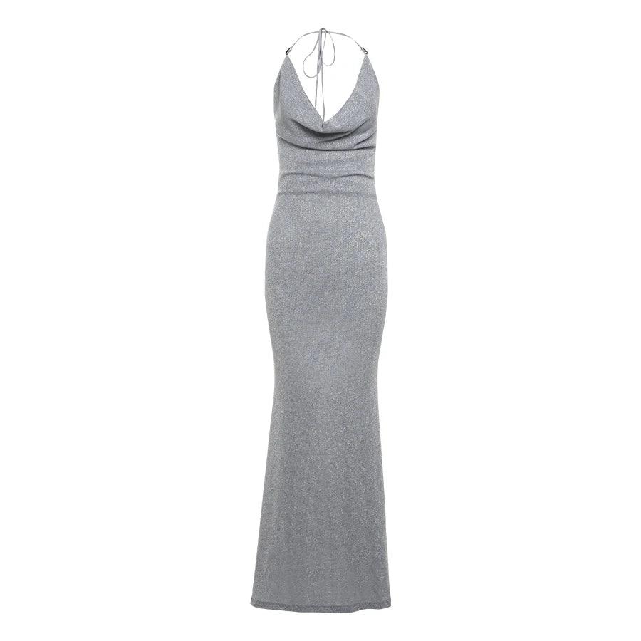 Silver shimmering maxi dress with a plunging neckline and open back, elegantly styled with a fitted silhouette.