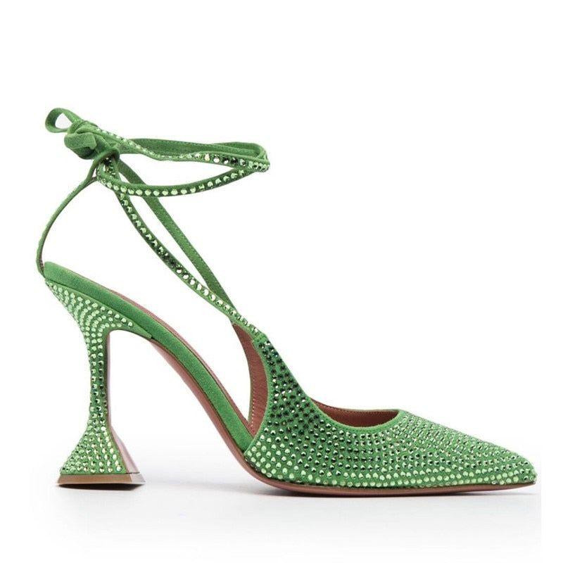 Green lace-up heels with high shine and crystal embellishments, featuring a chic pointed toe and distinctive heel design.