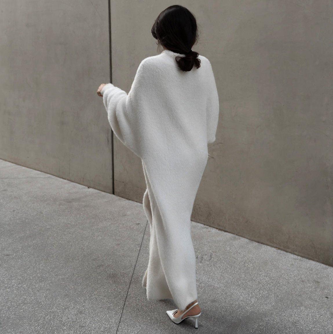 Oversized long sleeve cardigan in misty white, featuring a cozy knit design, styled open over a sleek outfit.