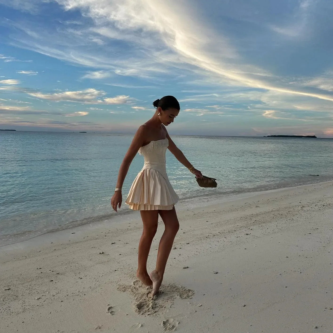 strapless ruffled mini dress with fitted bodice, relaxed beach look