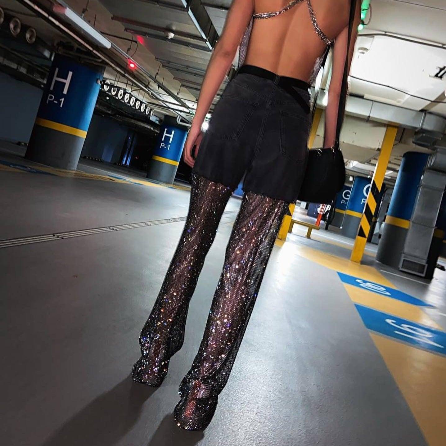 Backless top with glitter mesh pants and a mini skirt for a night-out look.