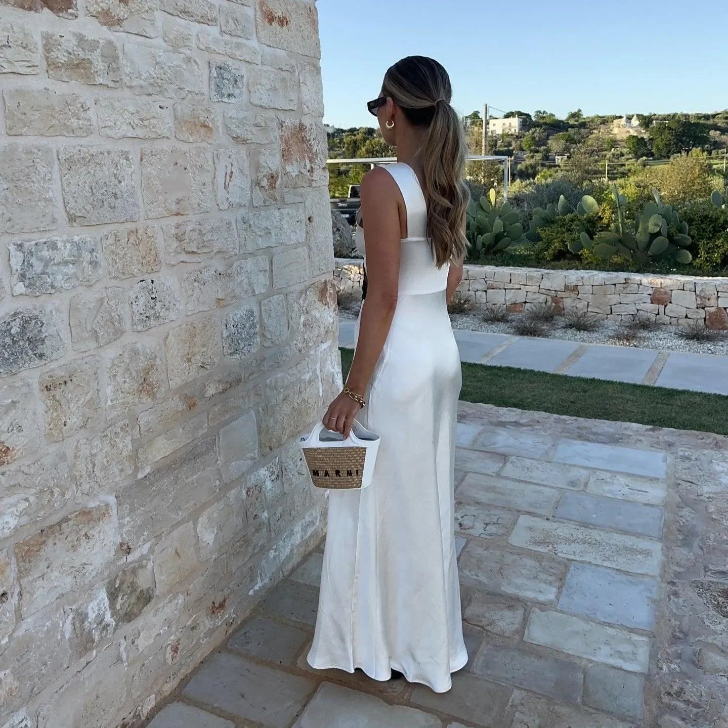 Satin maxi dress with square neckline and structured bag, evening look