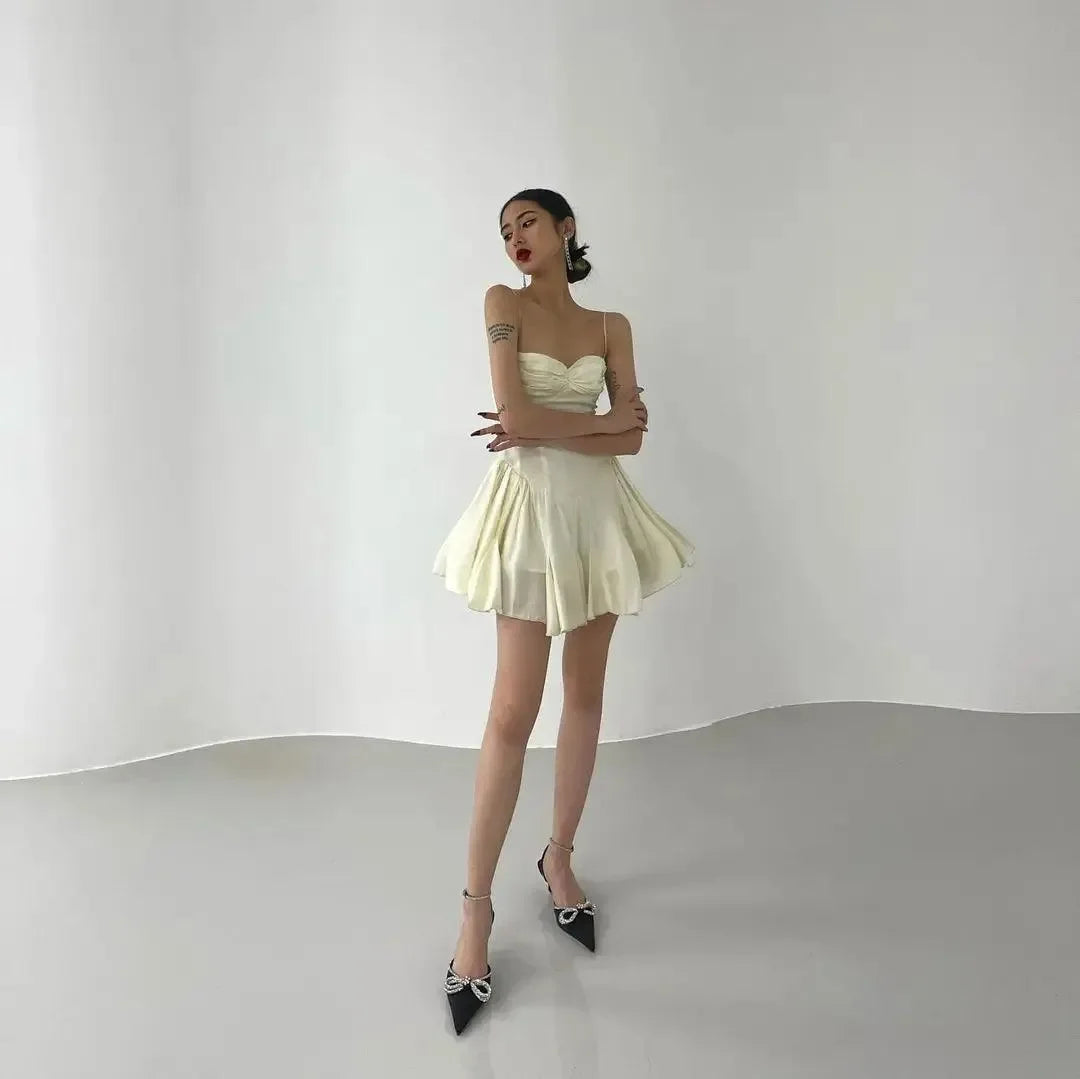 Cream satin mini dress with a flared skirt.