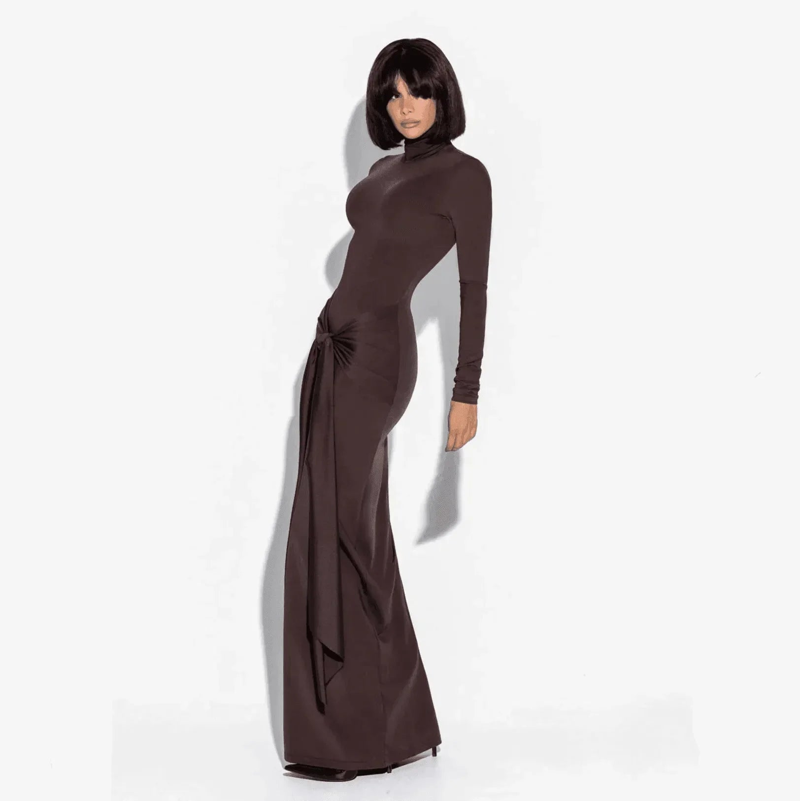 Long sleeve brown maxi dress with a fitted silhouette and a stylish knotted detail at the waist, perfect for elegant...