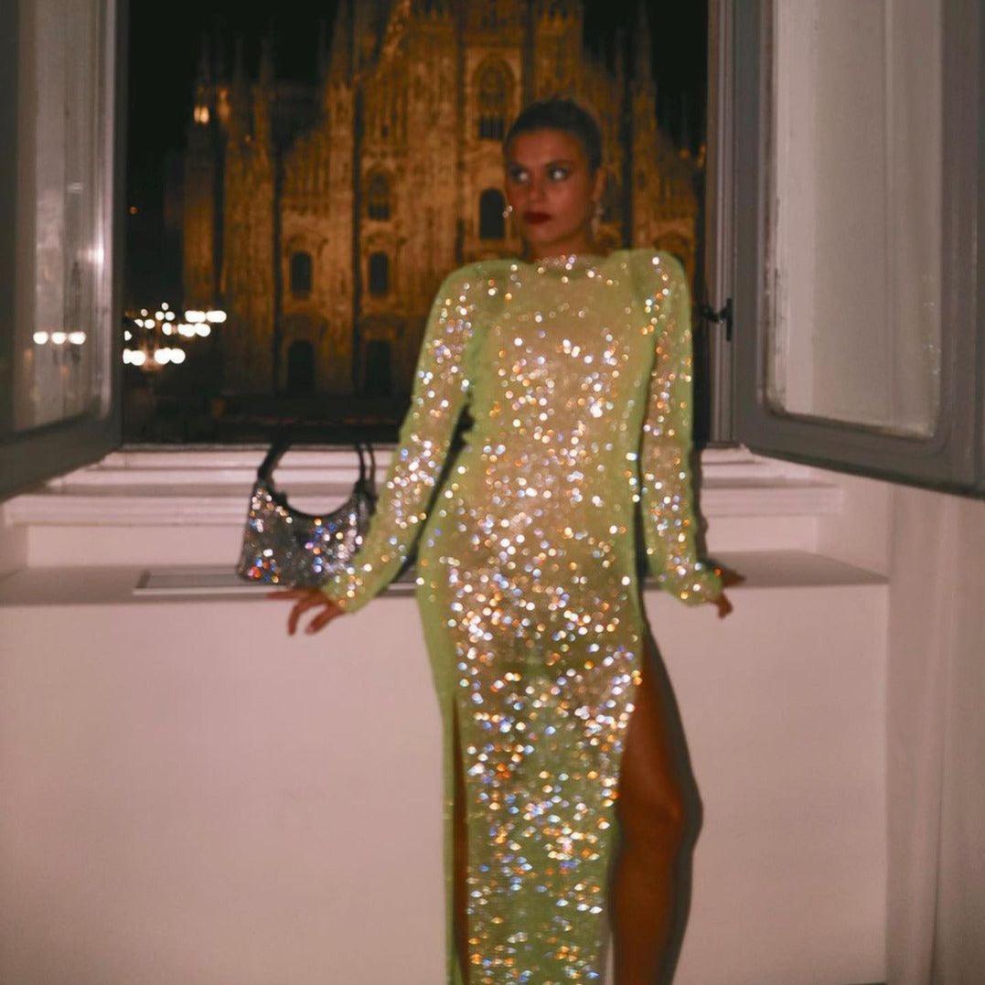 Light green rhinestone midi dress with a high slit, styled for an evening look, paired with a sparkling handbag.