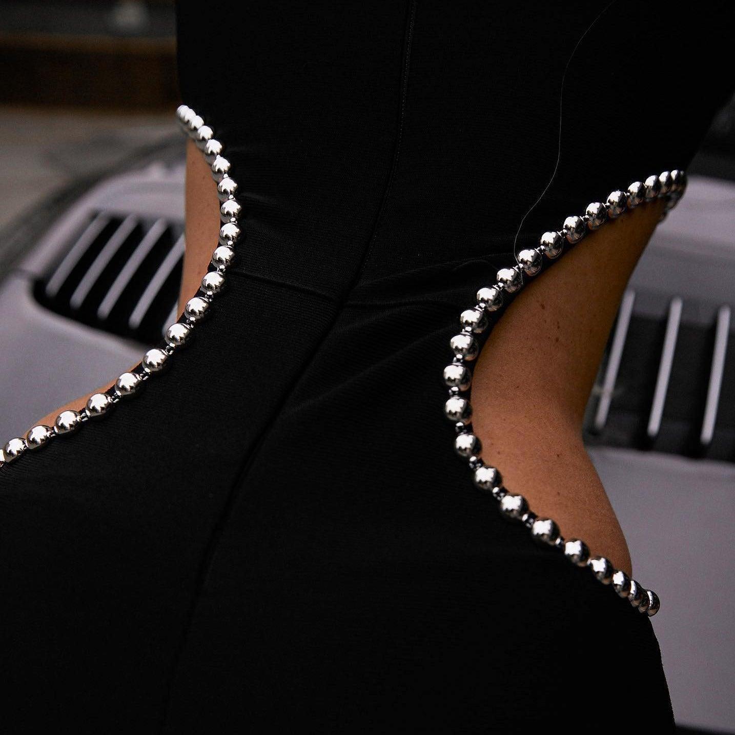 black cutout dress with metallic bead detailing, evening wear