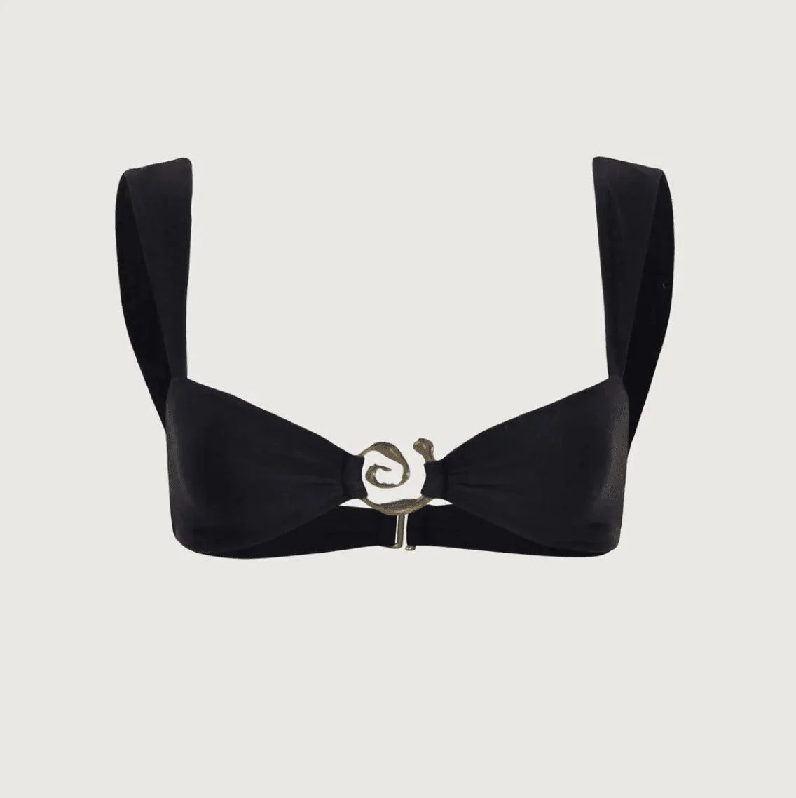 black top with structured straps and decorative swirl detail