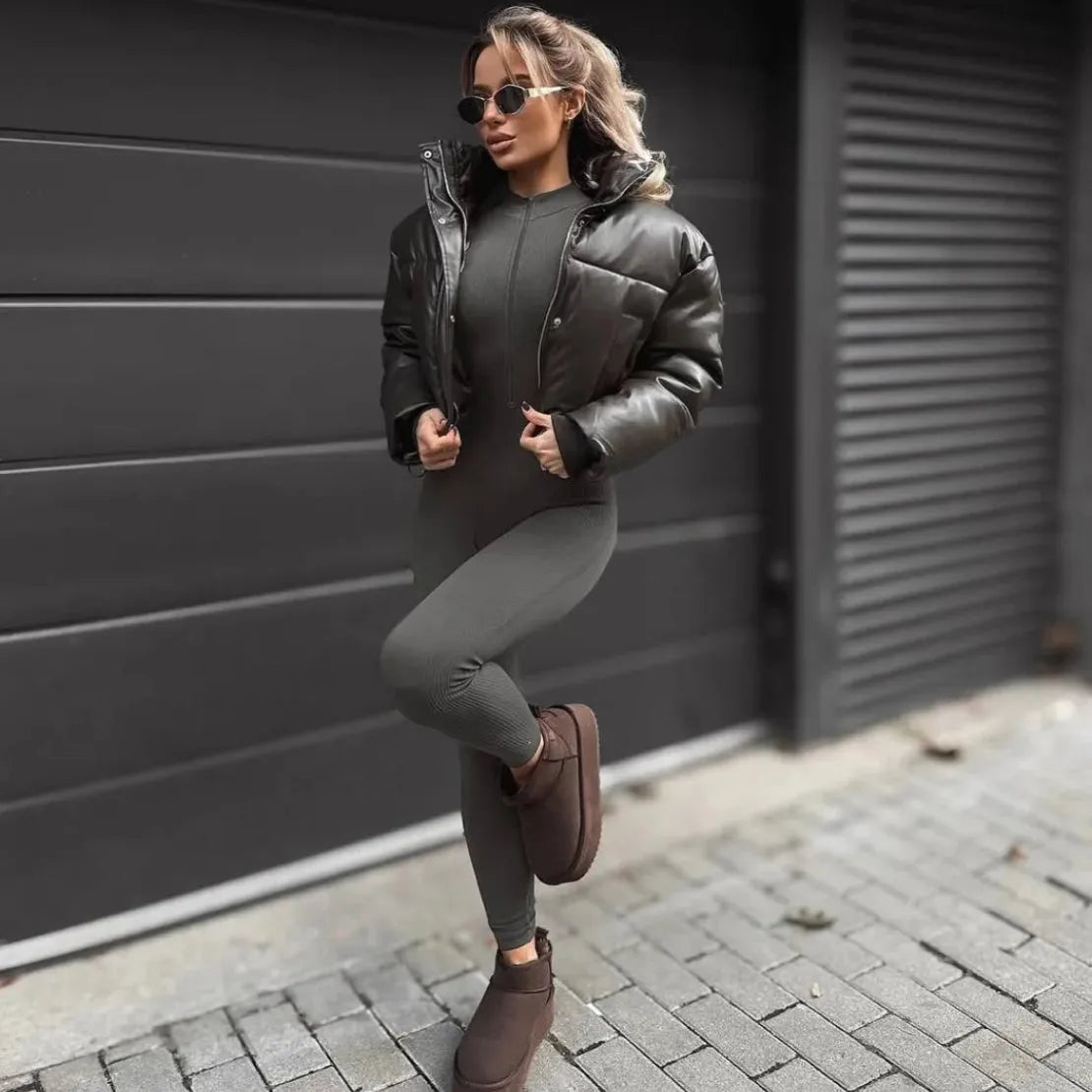 Gray long sleeve jumpsuit styled with a dark puffer jacket and cozy slippers, perfect for casual outings.