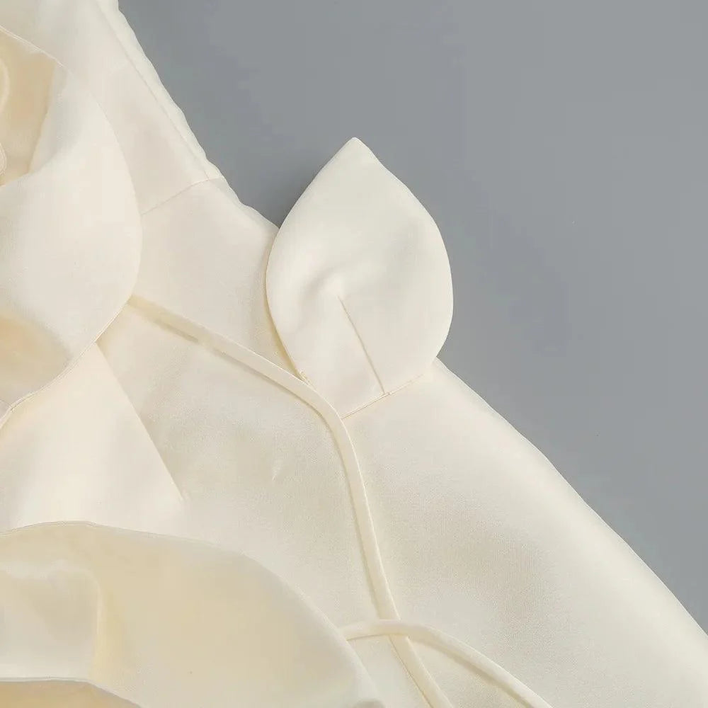 Ivory silk corset mini dress with voluminous flower details, featuring adjustable straps for a fitted silhouette.