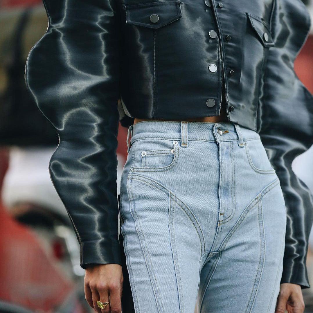 structured black jacket with wave pattern, light wash high-waisted jeans