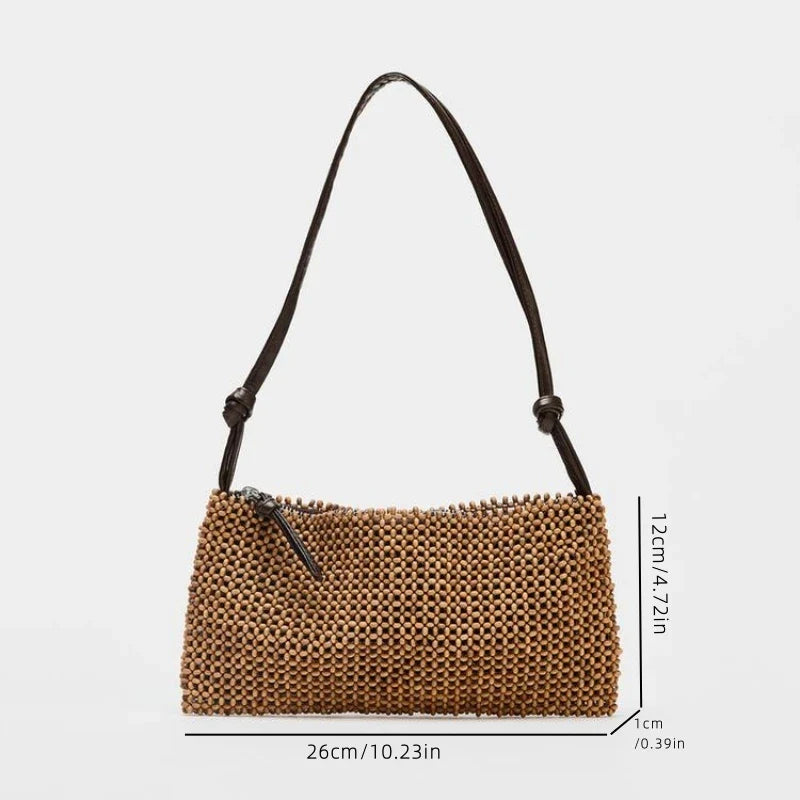 beaded handbag with zip closure and black strap