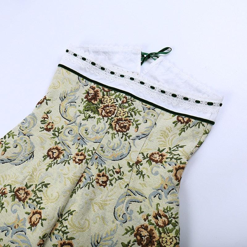 Floral corset-style mini dress in soft green with a lace trim and ribbon tie, perfect for a vintage-inspired look.