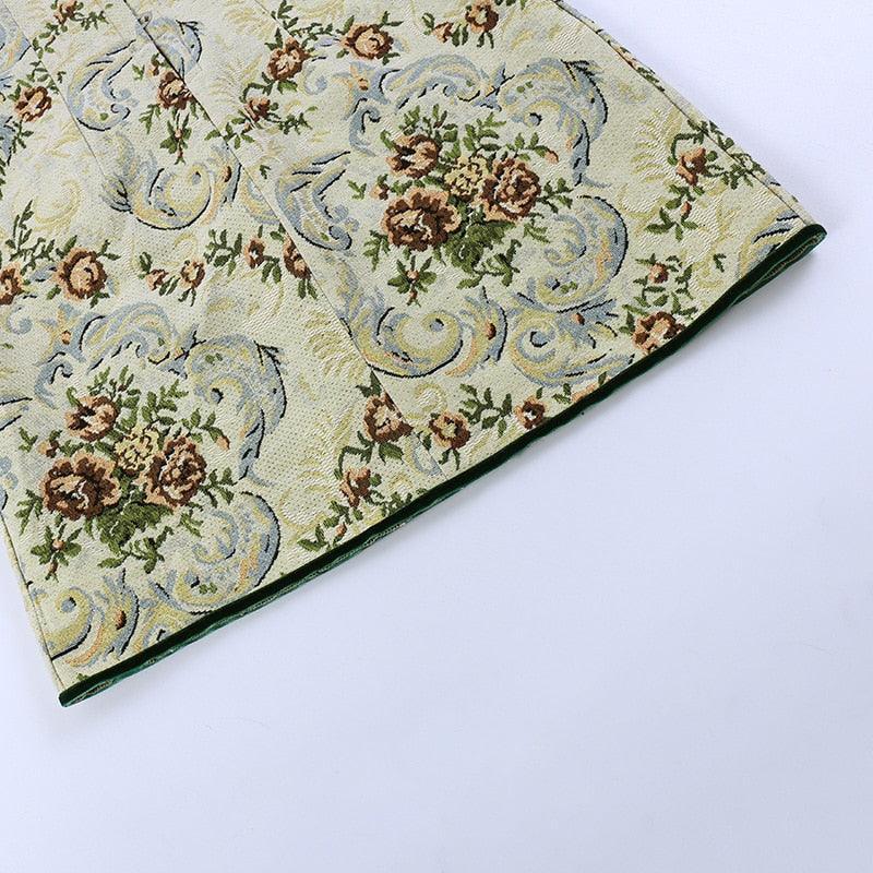 Vintage corset-style mini dress in pastel green with floral embroidery, featuring a fitted bodice and flared skirt....