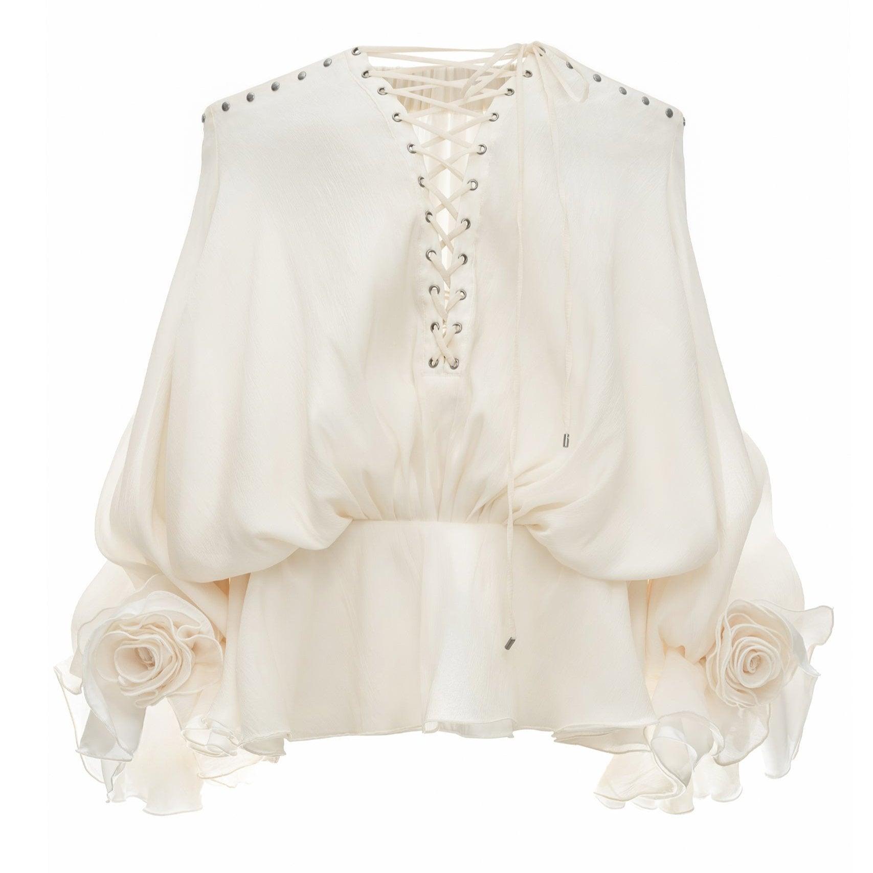 Off-shoulder ivory mini dress with lace-up front, voluminous sleeves, and floral accents at the hem. Perfect for summer...