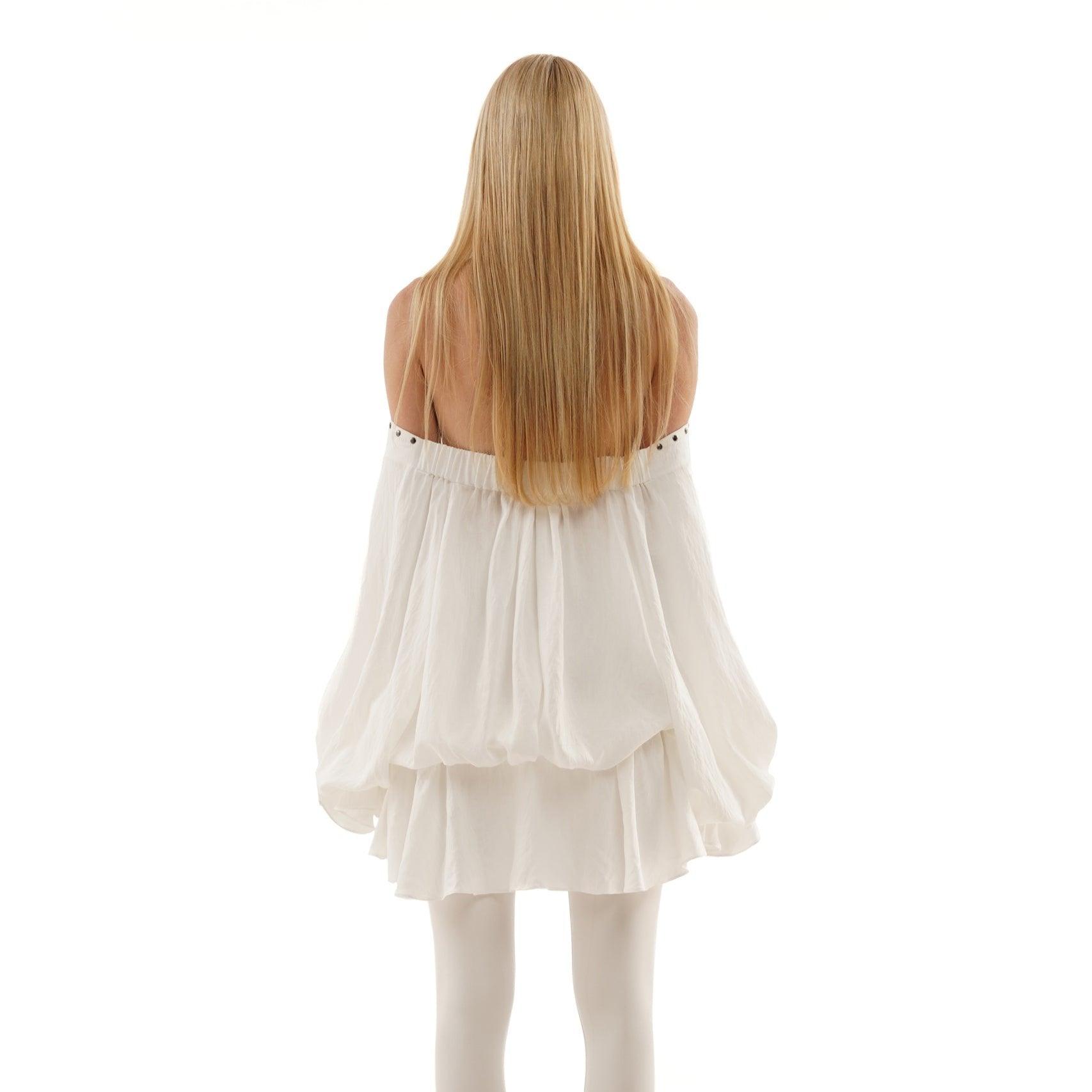 White off-shoulder mini dress with lace-up detail, featuring a flowy silhouette and styled for a chic, relaxed look.