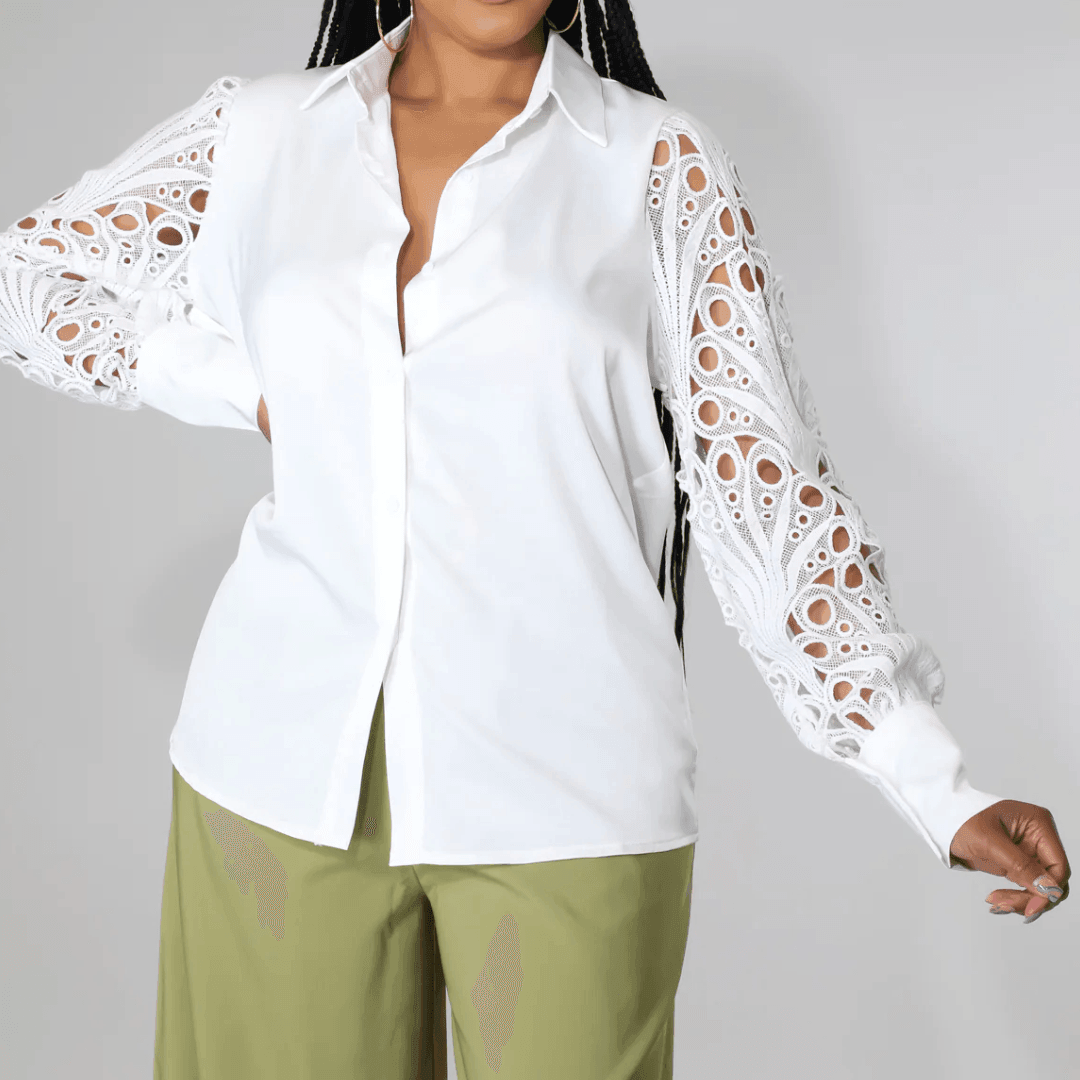 White blouse with lace puff sleeves, featuring button-up front, styled with loose olive green pants for a chic look.