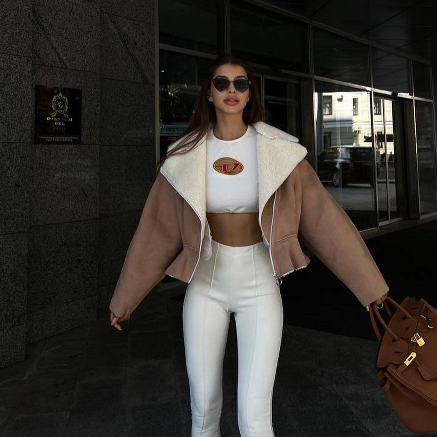 Cropped shearling jacket with high-waisted pants, casual daywear