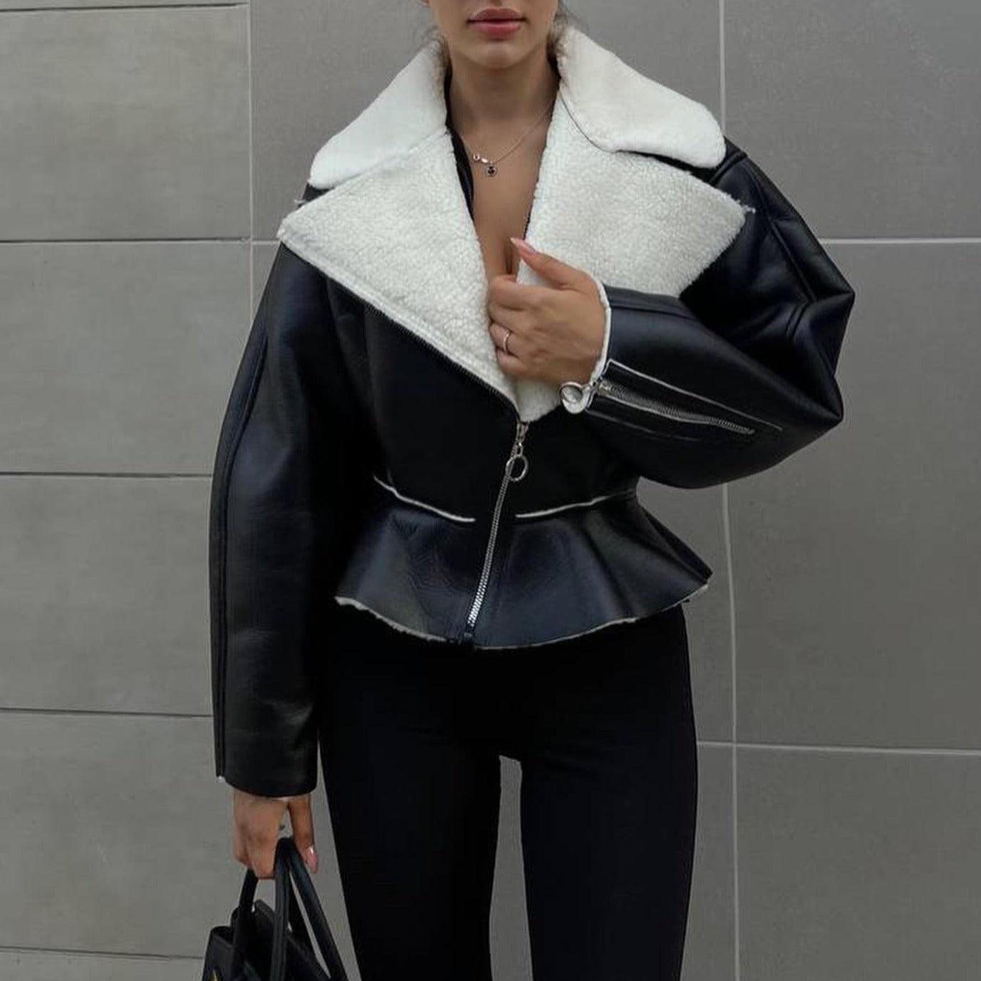 Black lambswool lapel jacket with a peplum waist, styled with fitted black leggings and a chic handbag.