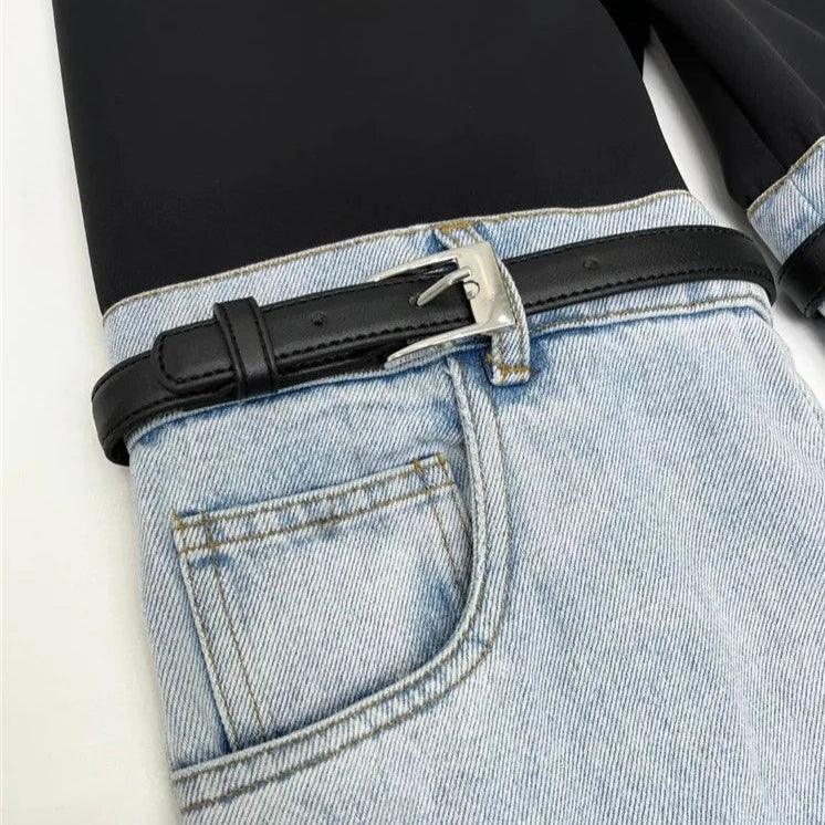 Black top with high-waisted light-wash jeans and a black belt.