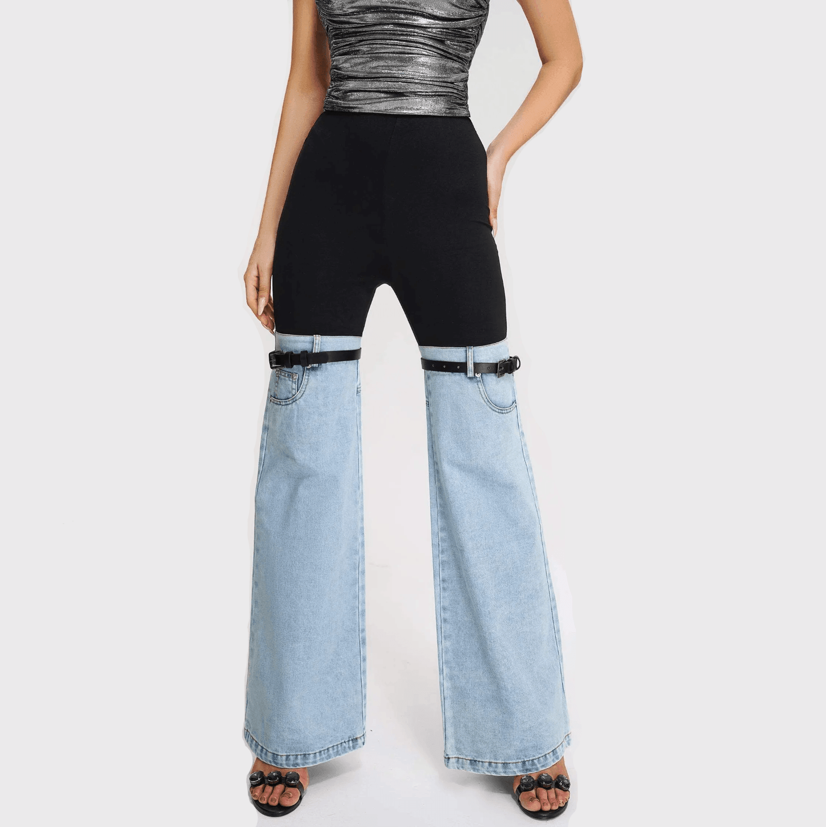 Black and light blue denim hybrid flare pants with adjustable straps, styled with a metallic top and heeled sandals.