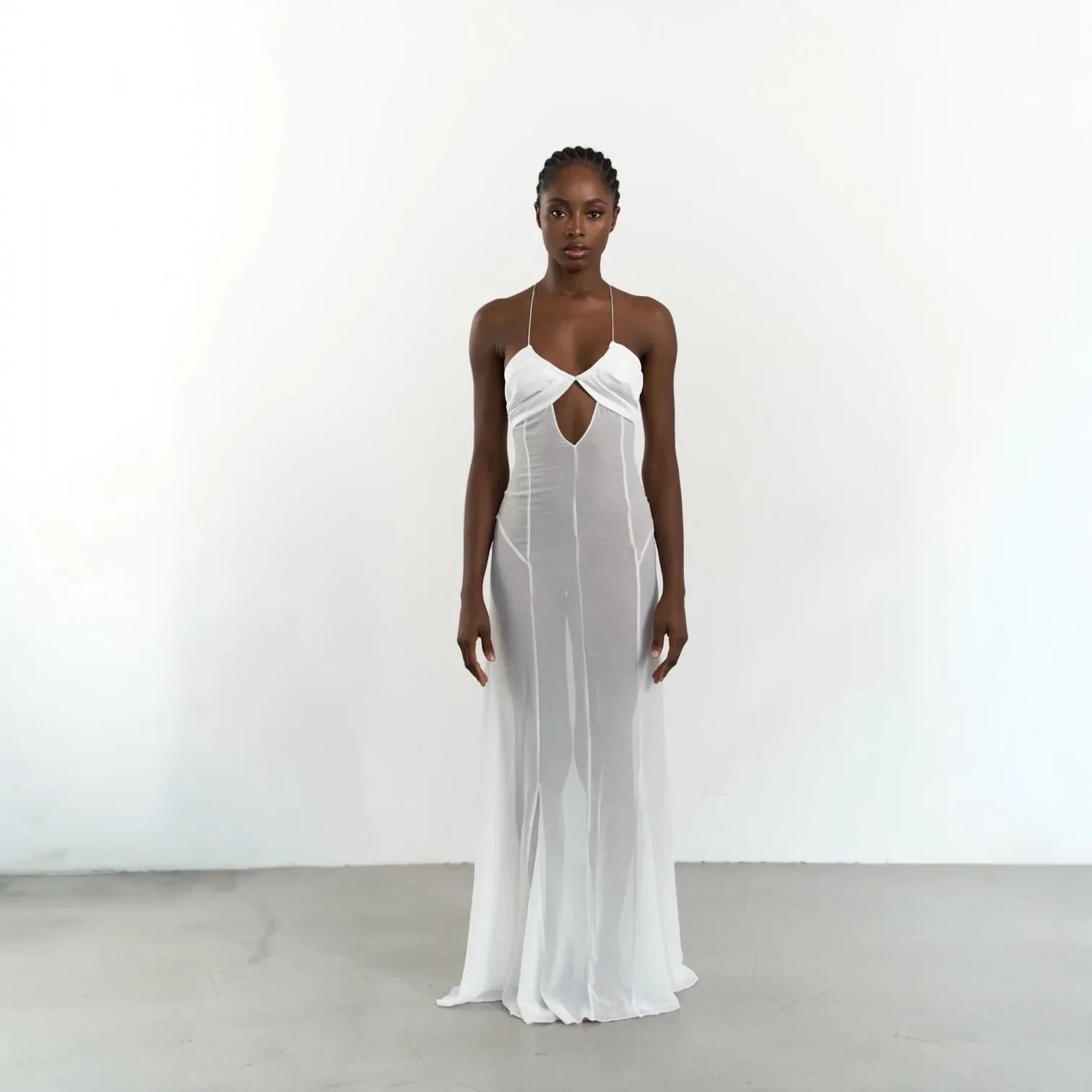 White maxi dress with mesh cutouts and lace-up detailing, featuring a flattering silhouette for chic summer outings.
