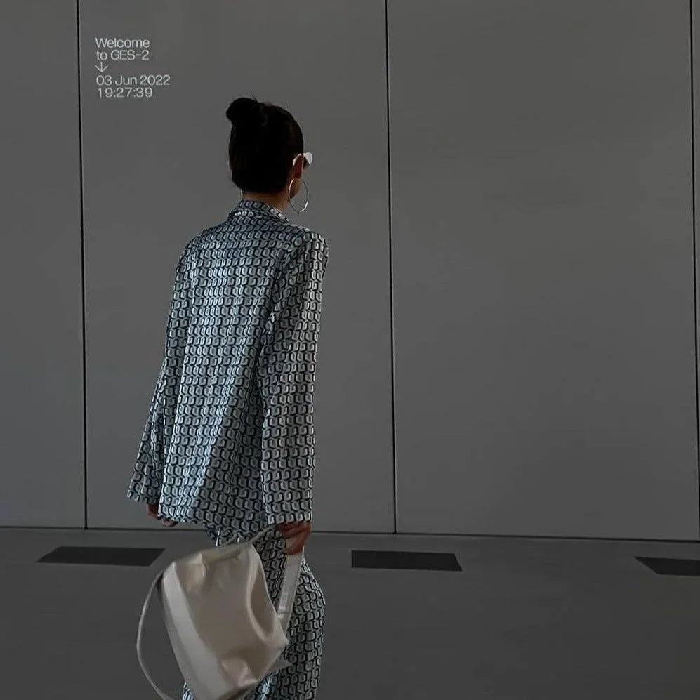 patterned blazer and trousers set with a white handbag