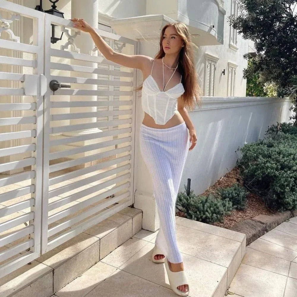 White corset top with striped pants for a stylish daytime look.