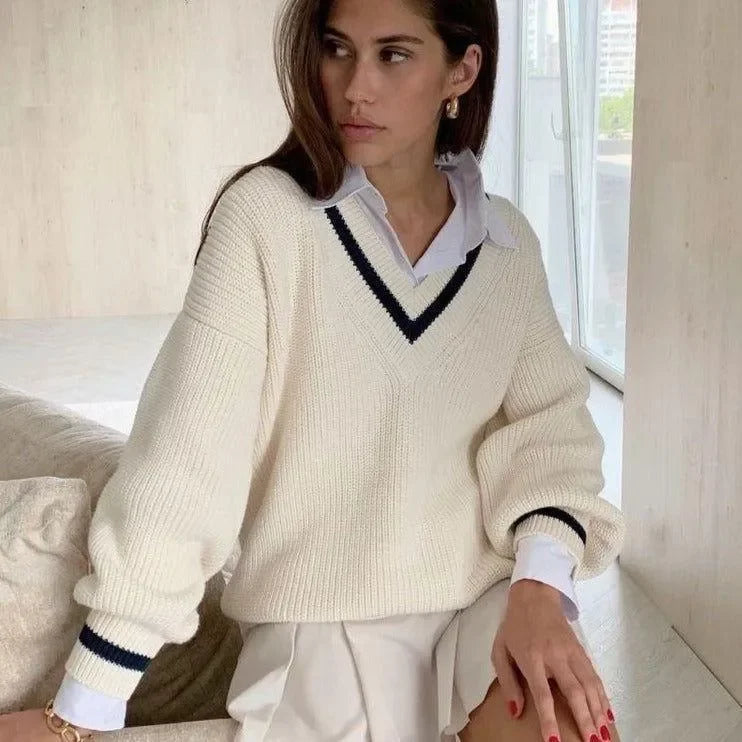 cream V-neck oversized sweater layered over white shirt, casual style