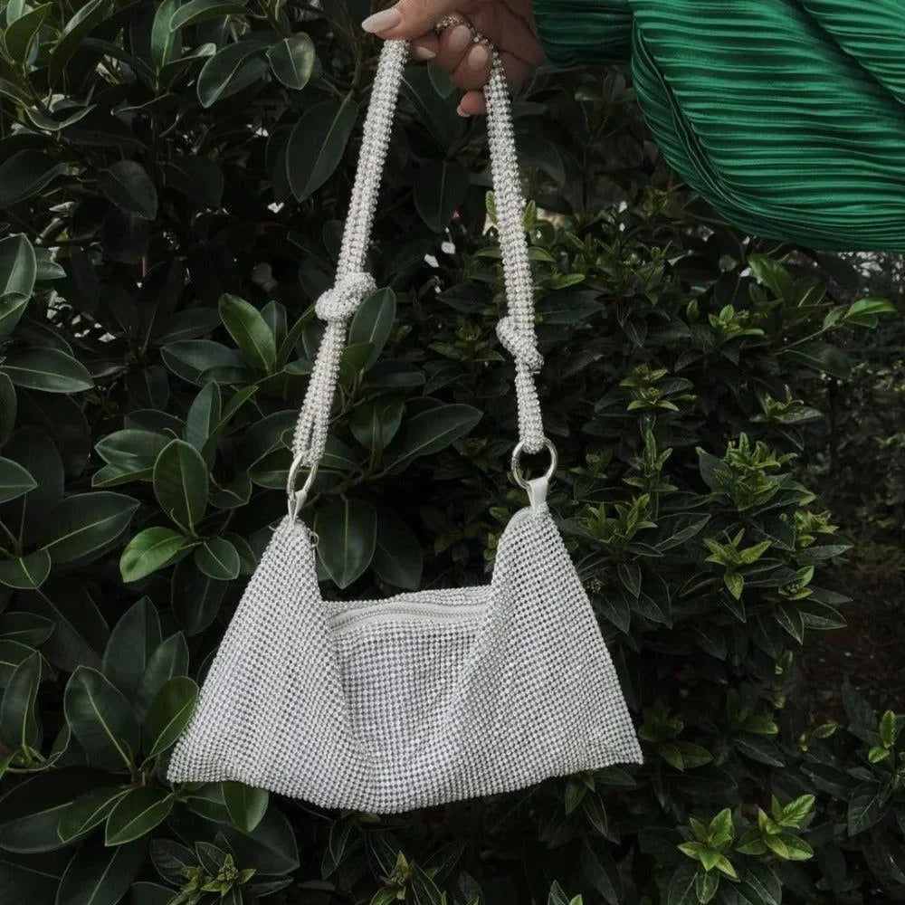 White beaded handbag with braided strap.