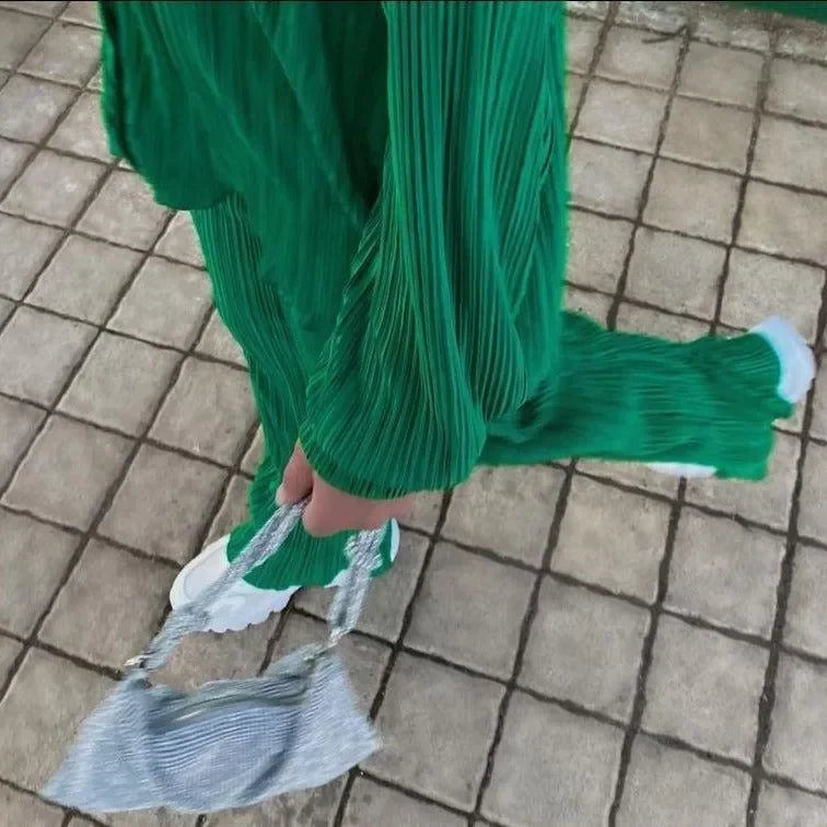 Green pleated matching set with silver textured handbag.