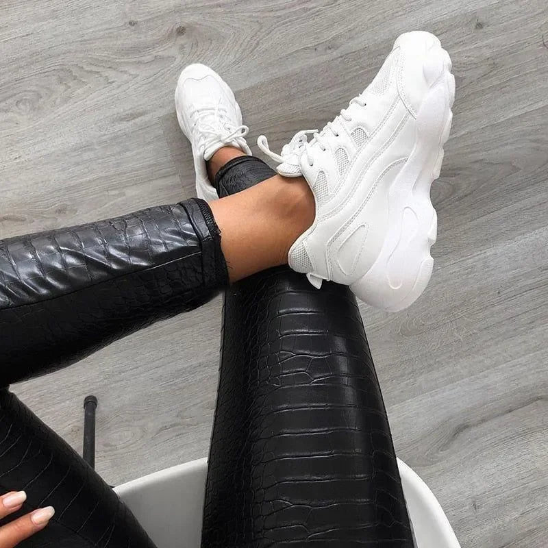white chunky sneakers with embossed leather leggings, casual look