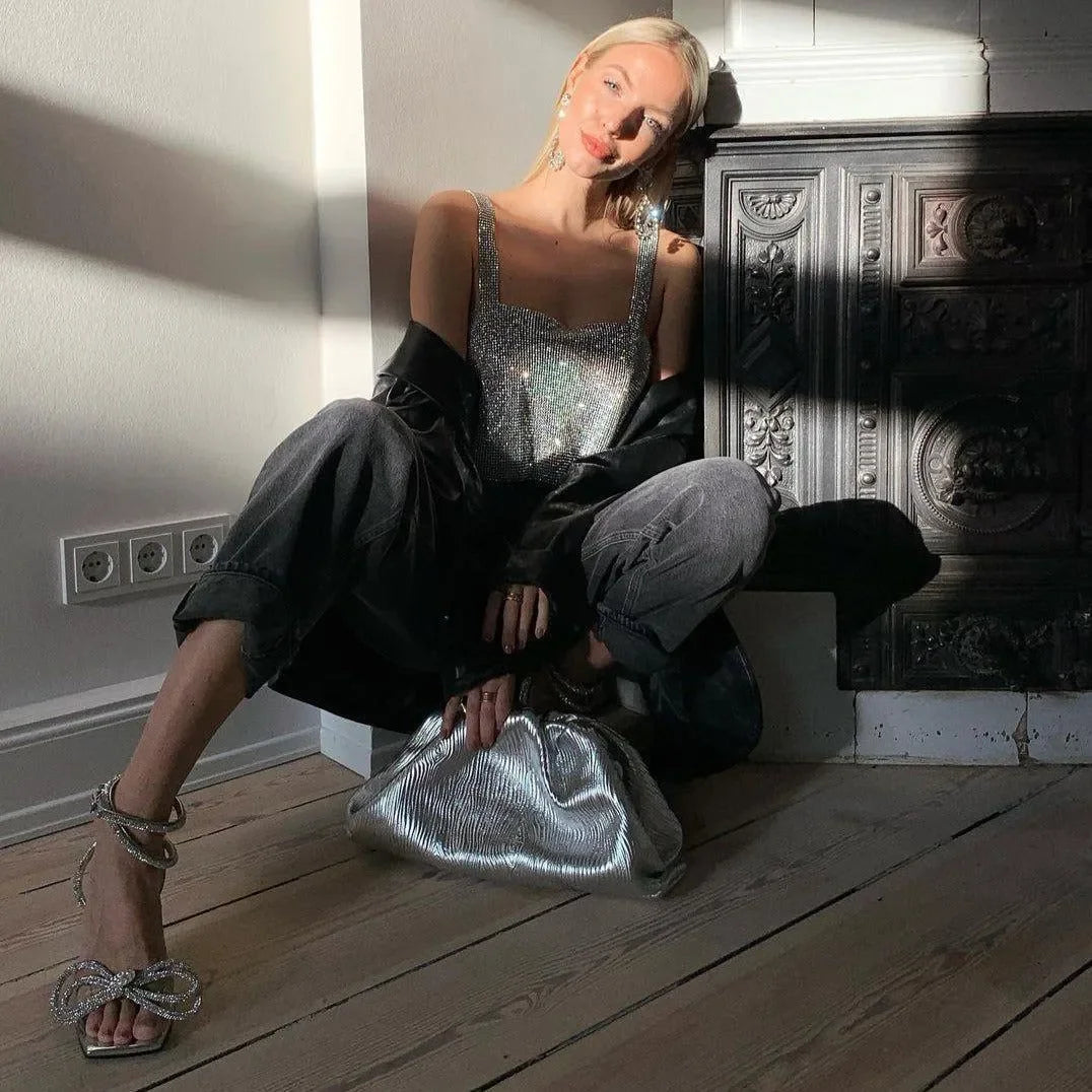 sequin top and oversized pants, evening look with metallic clutch and embellished heels