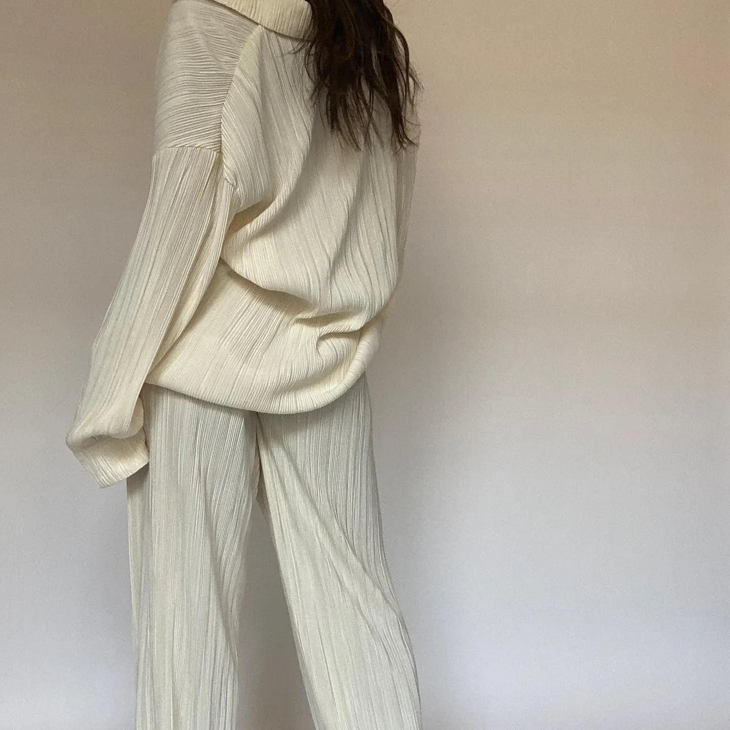 Cream pleated co-ord set with loose trousers and top.