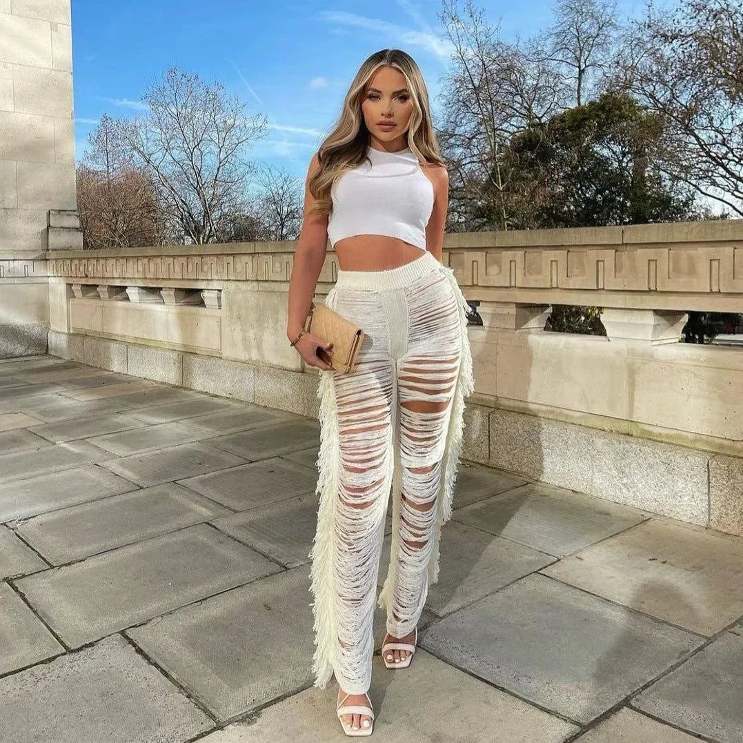 fringe distressed pants paired with a sleeveless crop top, casual chic look