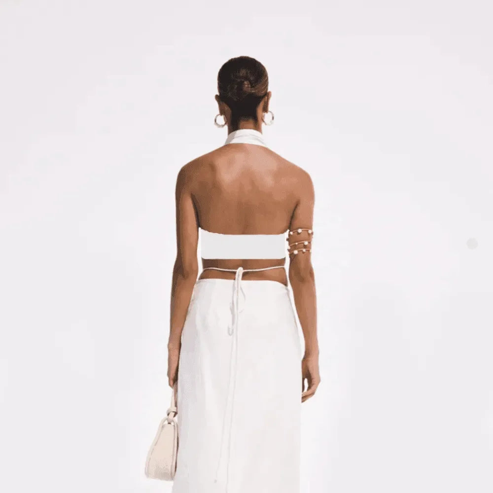 backless halter top with tie-back and high-waisted skirt, evening look
