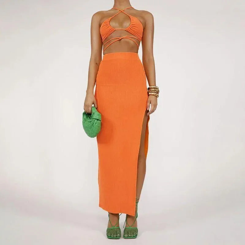 orange two-piece set with halter top and high-slit maxi skirt, party look